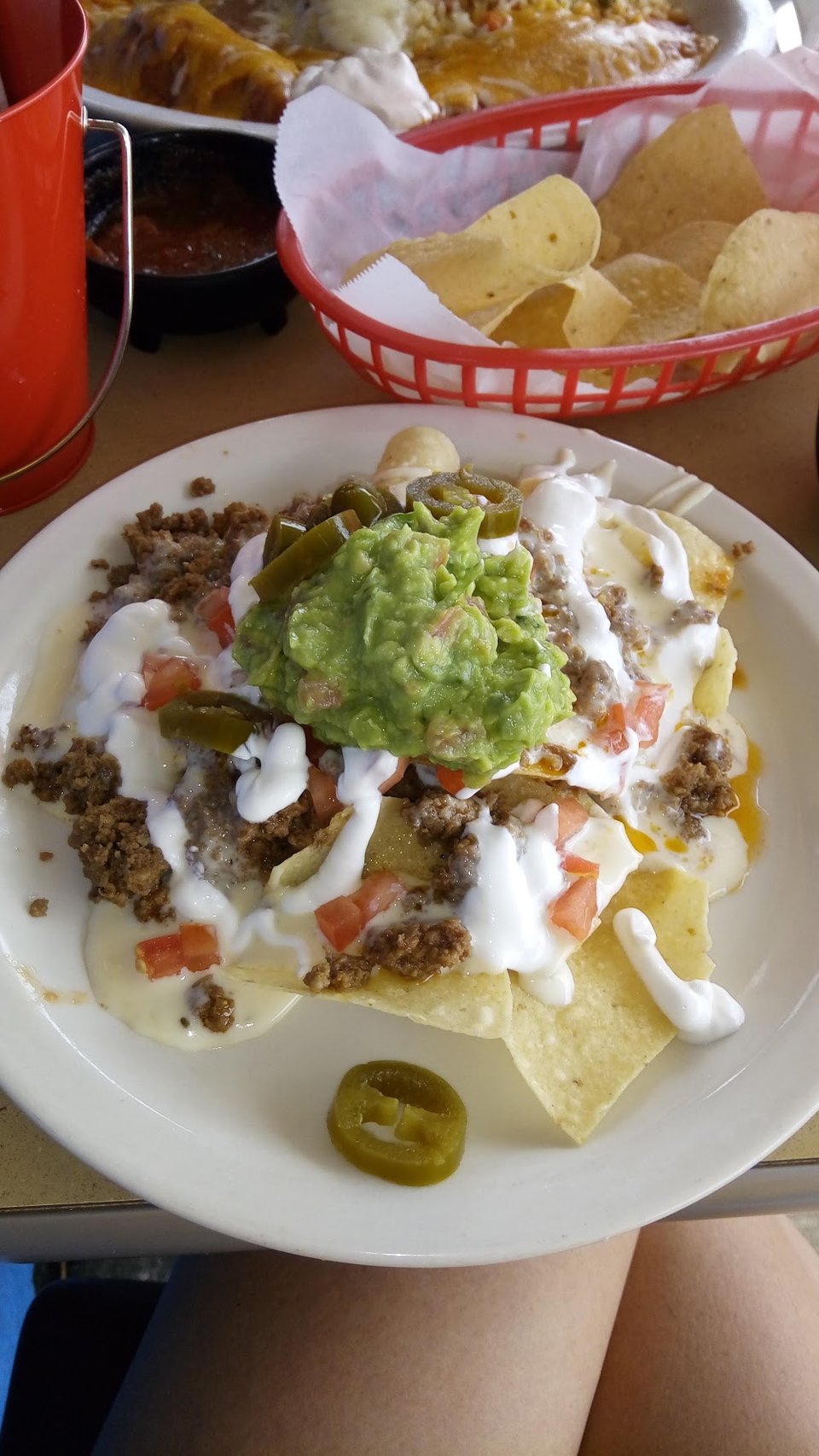 A spread of salads, nachos, and appetizers.